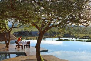 Best honeymoon destinations | A poolside table at Four Seasons Safari Lodge Serengeti